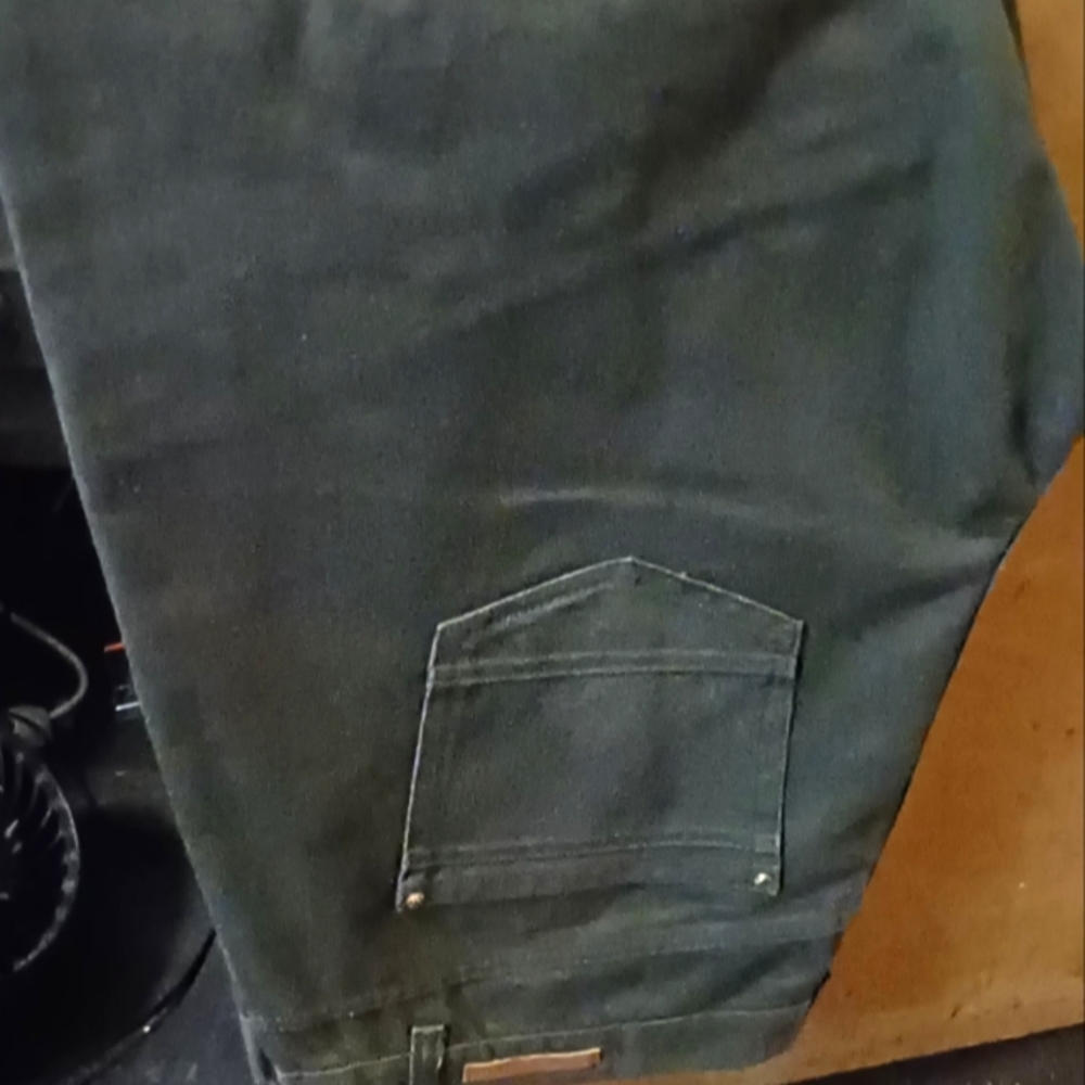 Unbranded Green Jeans with gold zipper pockets.